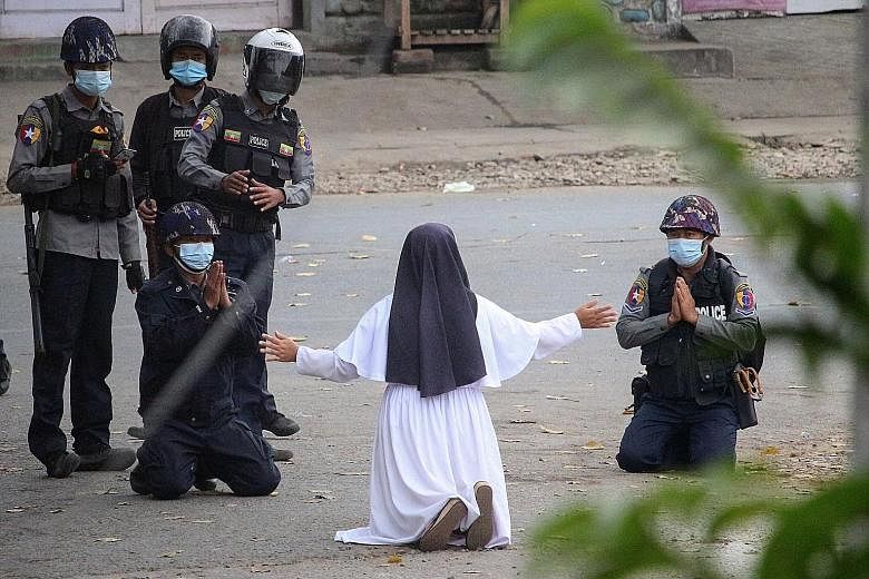 A nun kneeling on the street in Myanmar's north-east town of Myitkyina on Monday, pleading with the police to stop shooting protesters. Daily protests are being staged across the country, and security forces are cracking down harshly. Scattered ralli