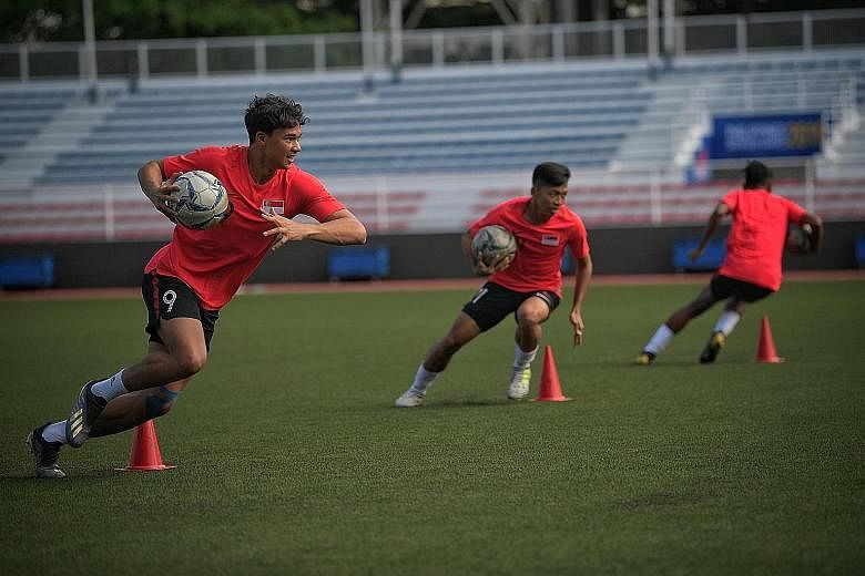 Ikhsan Fandi (left) training with the Lions ahead of the 2019 SEA Games, He completed NS the year before. ST FILE PHOTOS
