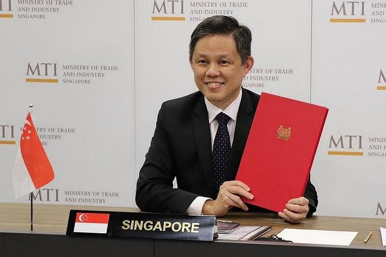 Singapore Minister for Trade and Industry Chan Chun Sing with the ratification document yesterday, when the bilateral investment treaty with Indonesia was ratified in a virtual meeting between the two sides.
