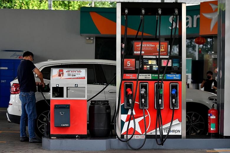 Motorists now have to pay more at the pump, with petrol duties raised last month for the first time in six years. But the Government has cushioned the financial blow with road tax rebates. ST PHOTO: LIM YAOHUI