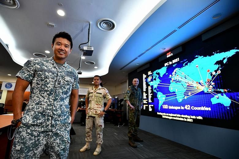 (From left) Lieutenant-Colonel Lester Yong, head of the Information Fusion Centre, with Lieutenant Sok Sal of Cambodia and Lieutenant Commander Christian Hegering of Germany at the centre at Changi Naval Base yesterday.
