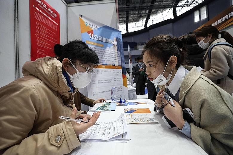 A job interview being conducted at a career fair in Wuhan, Hubei province, on Wednesday. China is aiming to create no fewer than 11 million jobs this year, and Chinese Premier Li Keqiang said yesterday that job creation is a top priority. PHOTO: AGEN