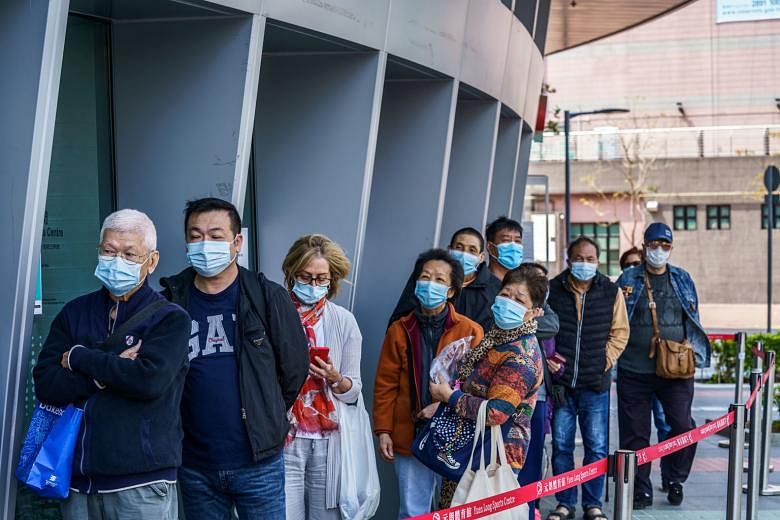 People waiting outside a community vaccination centre in Hong Kong on Wednesday for the Pfizer-BioNTech shot.