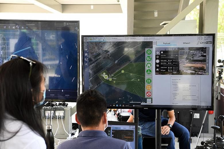 Above: A "command centre" set up for a media demonstration of the system. Top: During the demo, drones took off near Marina South Pier. Flight plans for several drones were uploaded to the system, which then monitored and managed the flights concurre