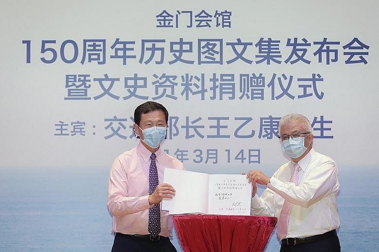 Transport Minister Ong Ye Kung and Kim Mui Hoey Kuan president Thomas Chua unveiling the new book, Our Voyage Through Time, at an event on Sunday to celebrate the Chinese clan association's 150th anniversary.