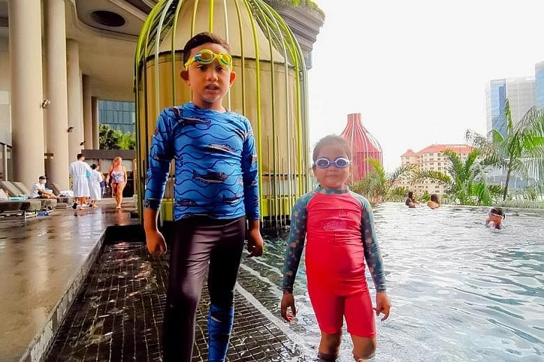 Mr Muhammad Atik's children, seven-year-old Arfan and six-year-old Arissa, by the swimming pool at Parkroyal Collection Pickering on Sunday. The family has since checked into Hilton Singapore.