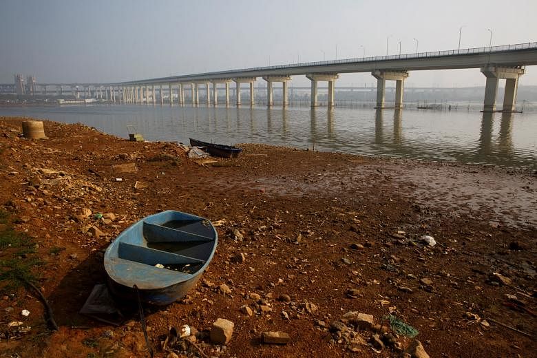 A boat lies ashore near the Jiujiang Yangtze River bridge linking Hubei province to Jiujiang city. Excessive sand mining in the Yangtze, which provides water for a third of the Chinese population, is said to be responsible for the abnormally low leve