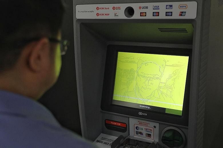 OCBC customers will be prompted to position their face within a frame on the ATM screen, while a Web-enabled camera scans their face and verifies it in real time against the national biometric database. ST PHOTO: ONG WEE JIN