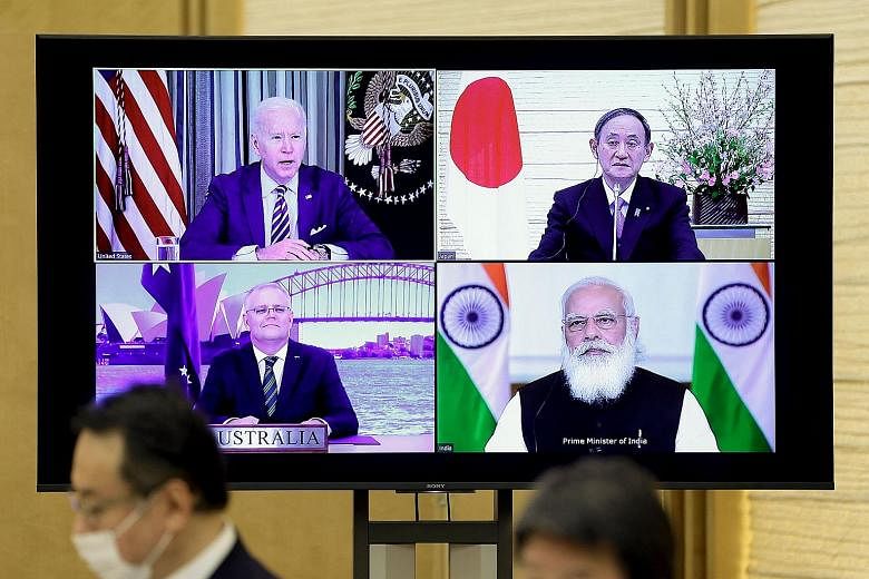 The virtual meeting of (clockwise from top left) US President Joe Biden, Japan's Prime Minister Yoshihide Suga, India's Prime Minister Narendra Modi and Australia's Prime Minister Scott Morrison during the Quadrilateral Security Dialogue, as seen at 