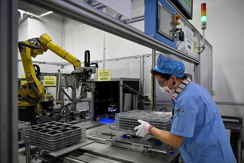 Jiejie Semiconductor Company employees at work in a factory in Nantong, in eastern China's Jiangsu province. China's shift into higher-value manufacturing, including semiconductors and components, has eroded the global market share of producers here,