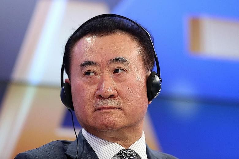 Trouble for Mr Wang Jianlin (above) - whose businesses range from entertainment to property (Tongzhou Wanda Plaza shopping mall in Beijing, right) - started in 2017 when banks halted funding for several of Dalian Wanda's global acquisitions. PHOTOS: 