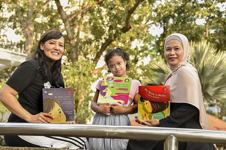 Ilyana Ali (left) wrote My Name Is Alyssa. I Have Down Syndrome, from the point of view of her daughter Nur Alyssa Mohd Azli (centre). The book is part of the I Am Unique series, which includes My Name Is Mikhail. I Have Cerebral Palsy, written by Hi