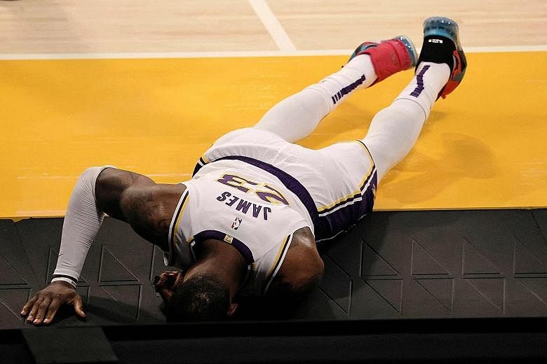 Lakers superstar LeBron James in agony on the Staples Centre court after a collision with the Hawks' Solomon Hill in the second quarter of Saturday's NBA game. The defending champions will have to do without him starting with last night's visit to th