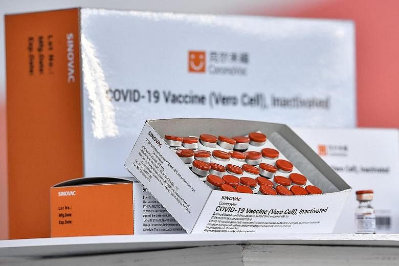 The Health Sciences Authority is awaiting additional data from vaccine maker Sinovac before it can complete its evaluation of the Chinese company's vaccine (above) and give its provisional approval. PHOTO: AGENCE FRANCE-PRESSE