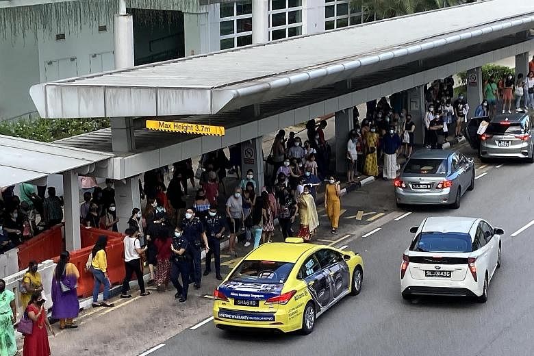 A crowd gathering at a taxi stand outside Sengkang MRT station yesterday morning, after a power fault disrupted train services between Serangoon and Punggol MRT stations.