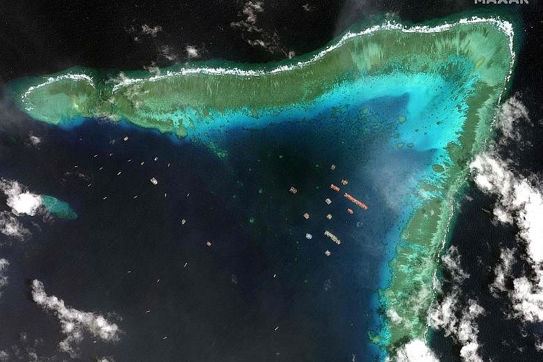 A satellite image taken last Tuesday that shows Chinese vessels anchored at the Whitsun Reef within the Philippines' exclusive economic zone in the South China Sea. Manila believes the over 200 Chinese boats are manned by maritime militia. PHOTO: AGE
