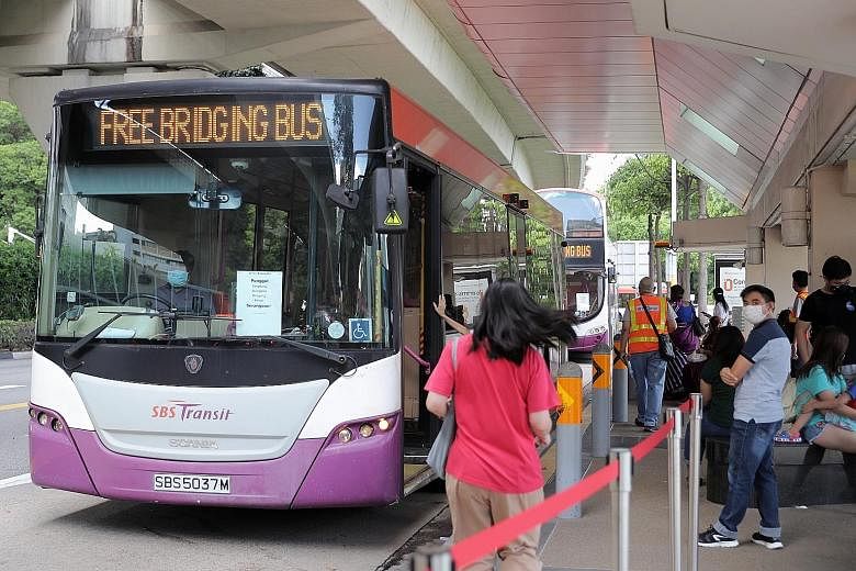 Train commuters had access to free regular and bridging bus services at designated bus stops between Serangoon and Punggol stations during the NEL disruption yesterday. ST PHOTO: GAVIN FOO