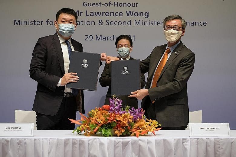 (From left) Sea founder and group chief executive Forrest Li, Education Minister Lawrence Wong and National University of Singapore president Tan Eng Chye at yesterday's signing ceremony, where the university received a $50 million donation - its lar