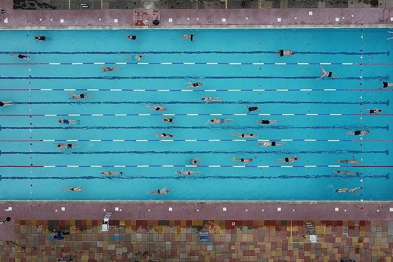 Swimmers taking to the waters yesterday in Hampton Lido in London, on the first day that outdoor pools were open following the easing of lockdown curbs amid the coronavirus pandemic in Britain.