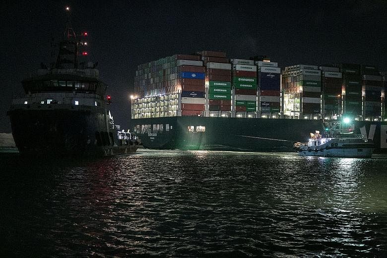 Tugboats working to dislodge the Ever Given from the bank of the Suez Canal last week. Now freed, there will be finger-pointing and competing agendas as cargo companies, lawyers, insurers and government agencies try to sort out what went wrong - and 