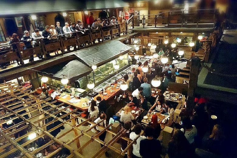 Unlike many other food and beverage businesses in Tokyo, Global-Dining's Gonpachi chain has resumed normal operating hours at its outlets, including the one in the Roppongi district (left), which inspired the backdrop of a scene in Quentin Tarantino'