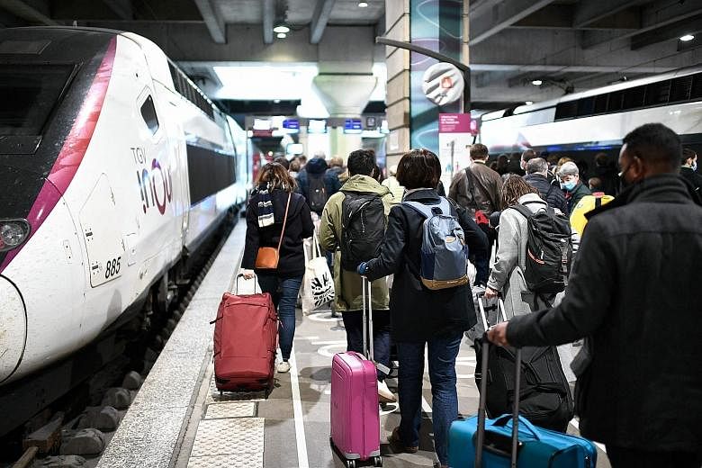 Passengers preparing to board a train on Saturday with their luggage at the Montparnasse rail station as France entered its third national lockdown to fight the pandemic.
