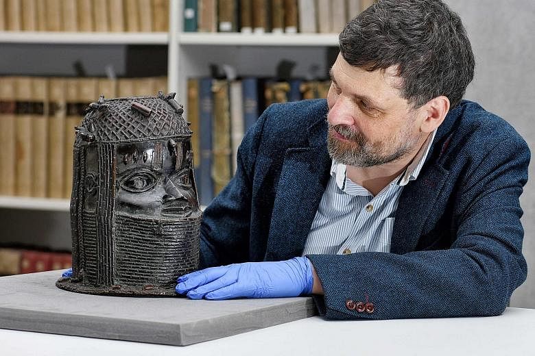 Mr Neil Curtis, head of museums and special collections at the University of Aberdeen, with a bronze sculpture depicting a king of Benin acquired at auction by the Scottish university in 1957.