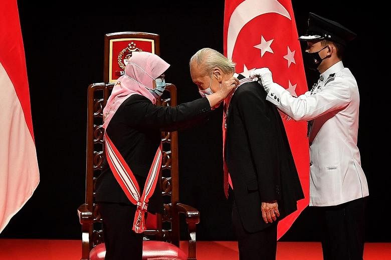 President Halimah Yacob presenting the Distinguished Service Order to Professor Wang Gungwu at the 2020 National Day Awards ceremony held at the Institute of Technical Education College Central yesterday. Prof Wang was recognised for his instrumental