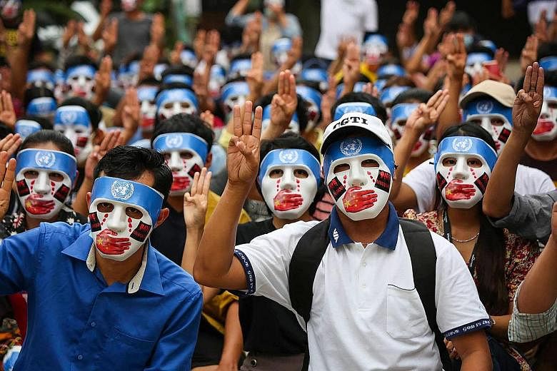 Protesters doing the three-finger salute at a rally in Yangon on Sunday.