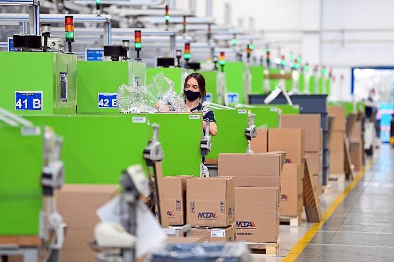 A worker at an Italian factory in February. While the US economy is bouncing, Britain, France, Germany, Italy and Japan are contracting, according to Bloomberg Economics' new set of nowcasts.