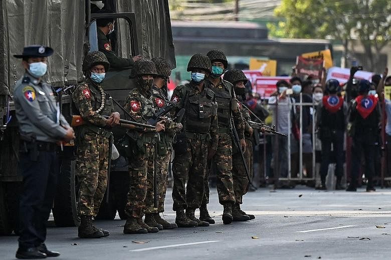 Myanmar soldiers standing guard during an anti-coup demonstration in Yangon in mid-February. The military, or Tatmadaw, has always played a central role in the Myanmar polity. If further bloodshed is to be minimised, the Tatmadaw's institutional inte