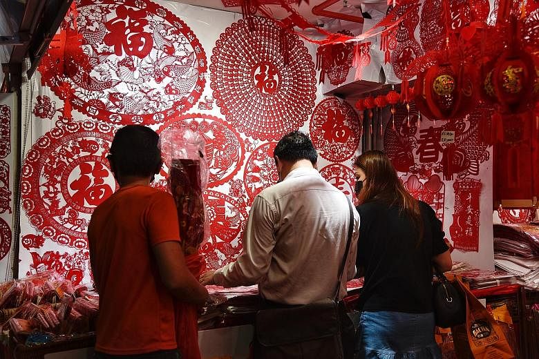 People shopping for decorations in Chinatown, ahead of Chinese New Year in February. The Department of Statistics said the improvement in retail sales in February was mainly associated with CNY celebrations that month, whereas last year, the festive 
