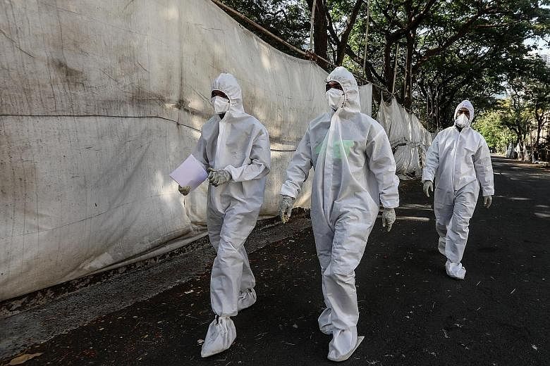 Health workers outside a quarantine centre in Mumbai, India, on Monday. The country is facing record-level infections.