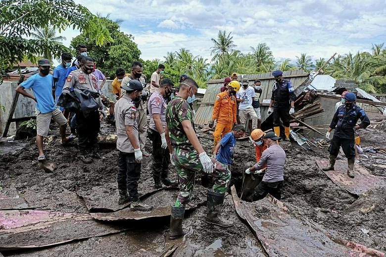 Rescuers searching for victims under the debris in a village in East Flores, Indonesia, yesterday after a flash flood hit the region on Sunday. Torrential rains from Tropical Cyclone Seroja caused floods and landslides that swept away villages in Ind