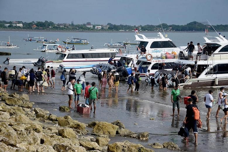 People preparing to board a fast boat from Sanur beach near Denpasar on the Indonesia resort island of Bali on Jan 7. Indonesian officials are in discussions with their counterparts in Singapore to allow limited travel to Indonesia.