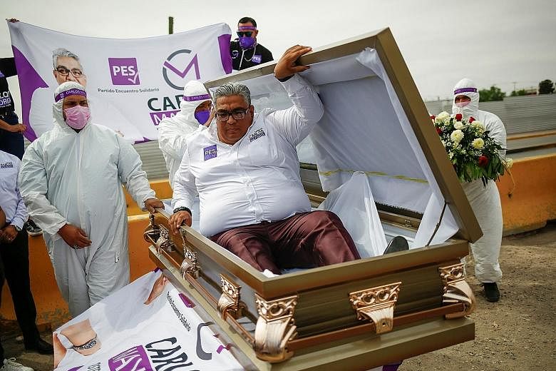 Mr Carlos Mayorga emerging from a coffin on Tuesday as part of his election campaign slogan "If I don't deliver, let them bury me alive". He is a Lower House candidate for the Encuentro Solidario party in the northern state of Chihuahua, Mexico.