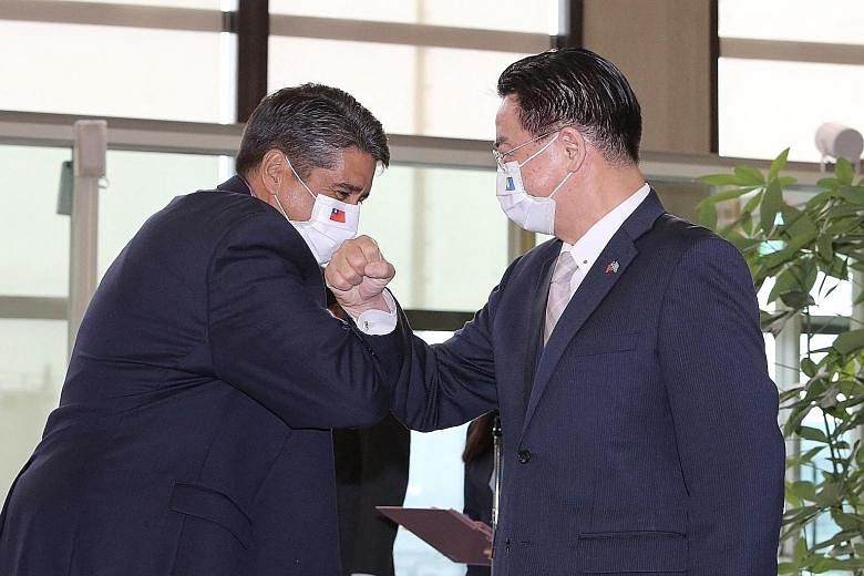 Palau's President Surangel Whipps Jr (left) bumping elbows with Taiwan's Foreign Minister Joseph Wu at Taoyuan International Airport in Taipei last month. The Pacific nation of around 21,000 people is one of 15 countries that still recognise Taiwan o