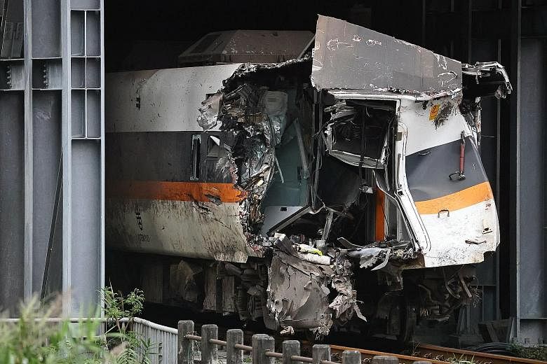 A damaged train carriage extracted on Tuesday from the site of the deadly derailment north of Hualien, Taiwan. The train crash near the famous Taroko Gorge last Friday killed at least 50 and injured 218. The Taiwan Railways Administration yesterday s