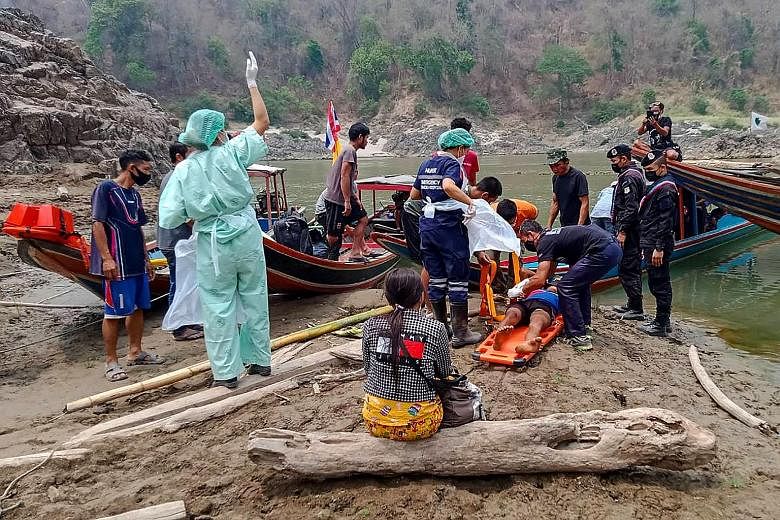 A handout photo from the Royal Thai Army on March 30 showing an injured Myanmar refugee being put on a stretcher before being taken to a hospital in Mae Sam Lap town after he crossed the Salween River while fleeing from air strikes in Myanmar's easte
