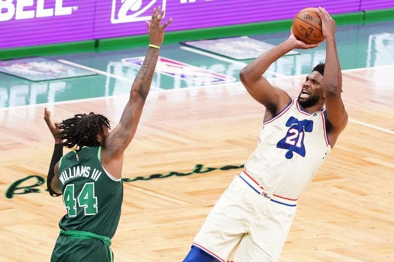 Sixers' Joel Embiid attempting a three over Celtics' Robert Williams on Tuesday. He made one of five treys but had a game-high 35 points. PHOTO: REUTERS