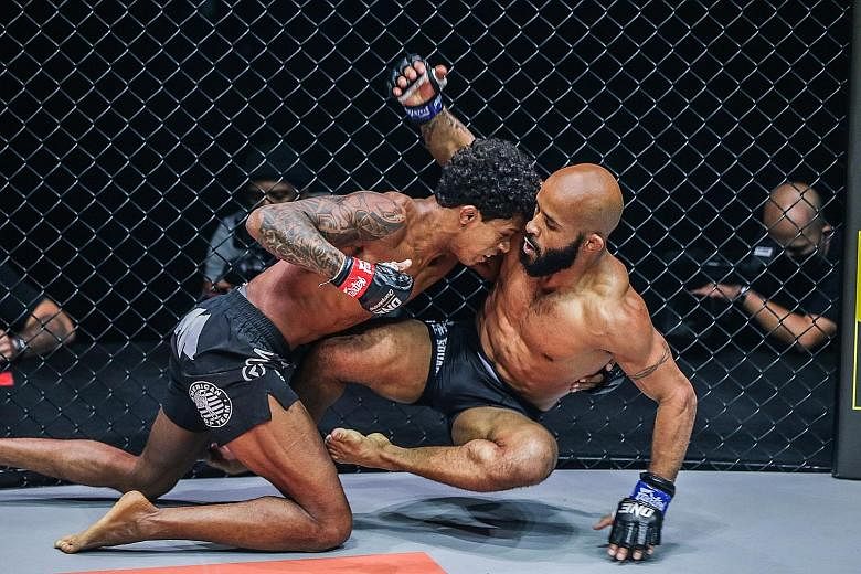 One Championship flyweight world champion Adriano Moraes (left) beat Demetrious Johnson at the One on TNT 1 event at the Singapore Indoor Stadium yesterday.