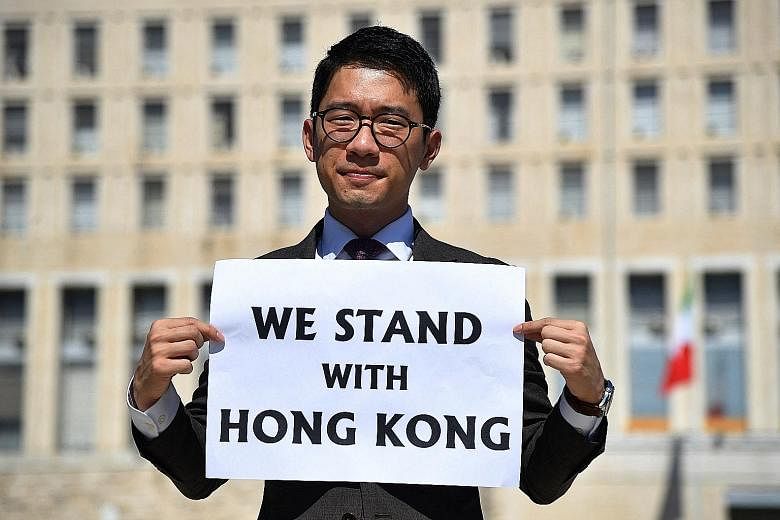 Hong Kong pro-democracy activist Nathan Law with a placard outside the Italian Foreign Ministry headquarters in Rome as he spoke to the media last August.