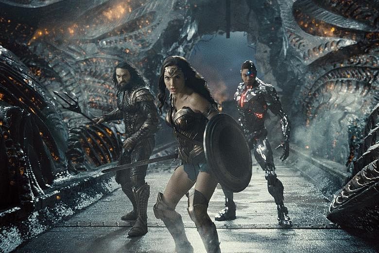 Director Joss Whedon allegedly threatened to harm the career of Gal Gadot (centre), who plays Wonder Woman in Justice League, after they clashed over his take on the movie.