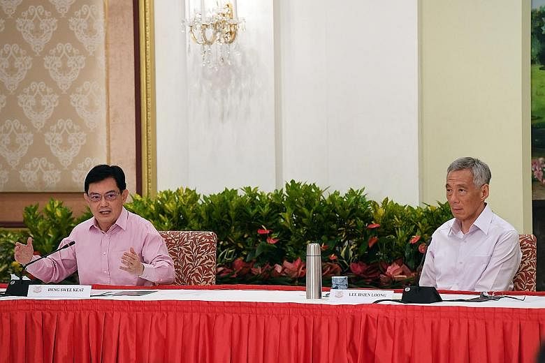 Deputy Prime Minister Heng Swee Keat and Prime Minister Lee Hsien Loong at the news conference at the Istana yesterday. Mr Heng said he made the decision to step aside as leader of the 4G team with the best interests of Singapore at heart, and PM Lee