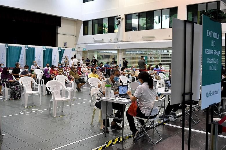 People at a Covid-19 vaccination centre in Hong Kah North Community Club last month. The swift global deployment of safe and effective vaccines remains the cornerstone in dealing with this public health crisis, says the writer.