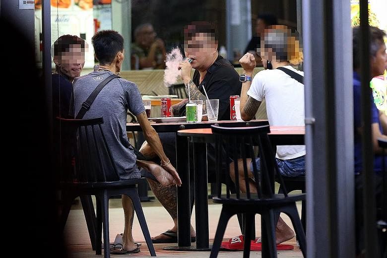 Top: E-vaporiser users openly puffing away at a coffee shop in Woodlands. Above: Dr Aneez Ahmed, who has operated on vapers suffering from collapsed lungs, says that even when there is no nicotine involved, inhaling the mist from e-vaporisers may dam