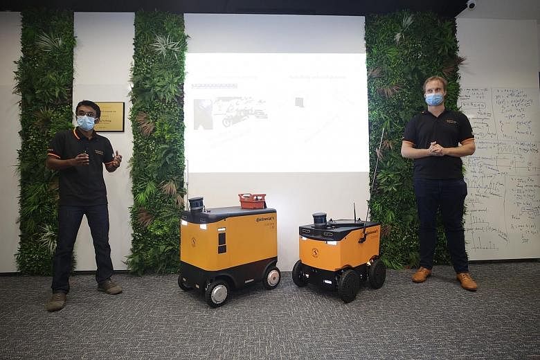 Continental-NTU Corporate Lab co-principal investigators Namal Senarathne (at left) and Michael Hoy presenting the German tech firm's scalable and modular autonomous delivery robot platform Corriere at the Nanyang Technological University's Research 