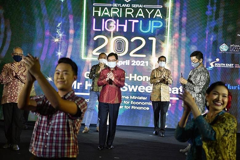 Above: This year's 40 light installations stretch along Sims Avenue starting at Paya Lebar Quarter, and Changi Road (above) and Geylang Road, starting at CharisTurf. Left: Deputy Prime Minister Heng Swee Keat at the light-up with (from left) Minister