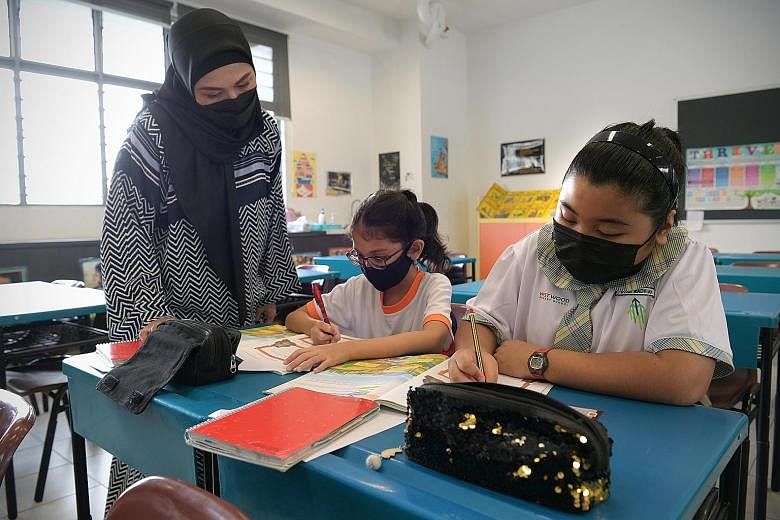 Malay language teacher Khaizuran Supa'at and her pupils during a Higher Malay lesson yesterday at Westwood Primary School. She says the Higher Malay curriculum allows teachers to stretch high performing pupils to help them reach their fullest potenti