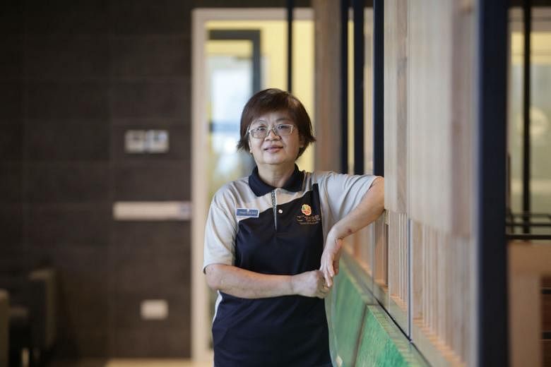 Madam Chong Nyok Mooi, 56, at Gochi-So Shokudo in Jurong does food preparation in the kitchen while also filling customer service roles, such as ensuring patrons scan their token or TraceTogether app. 